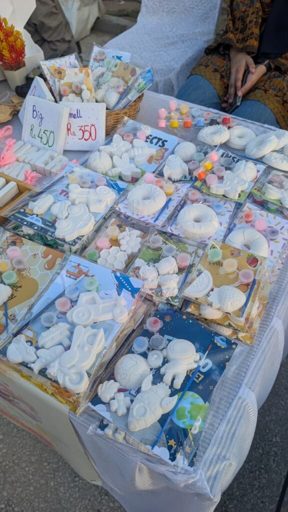 Market display of Nooru’s Happy Palette painting kits including the Space Kit
